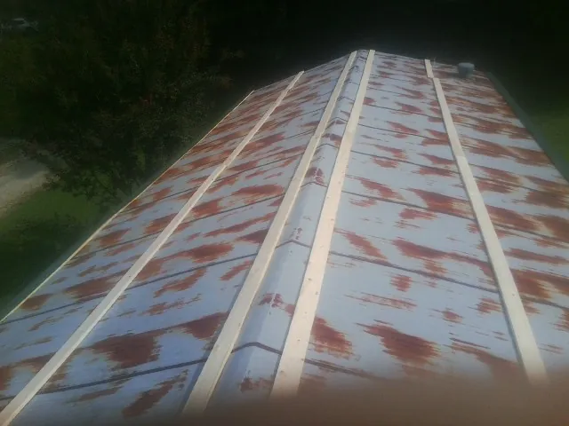 Rusted metal roof panels with new wood purlins before replacement — Storm Damage Roof Repair in Shippingport by Roofing Brothers