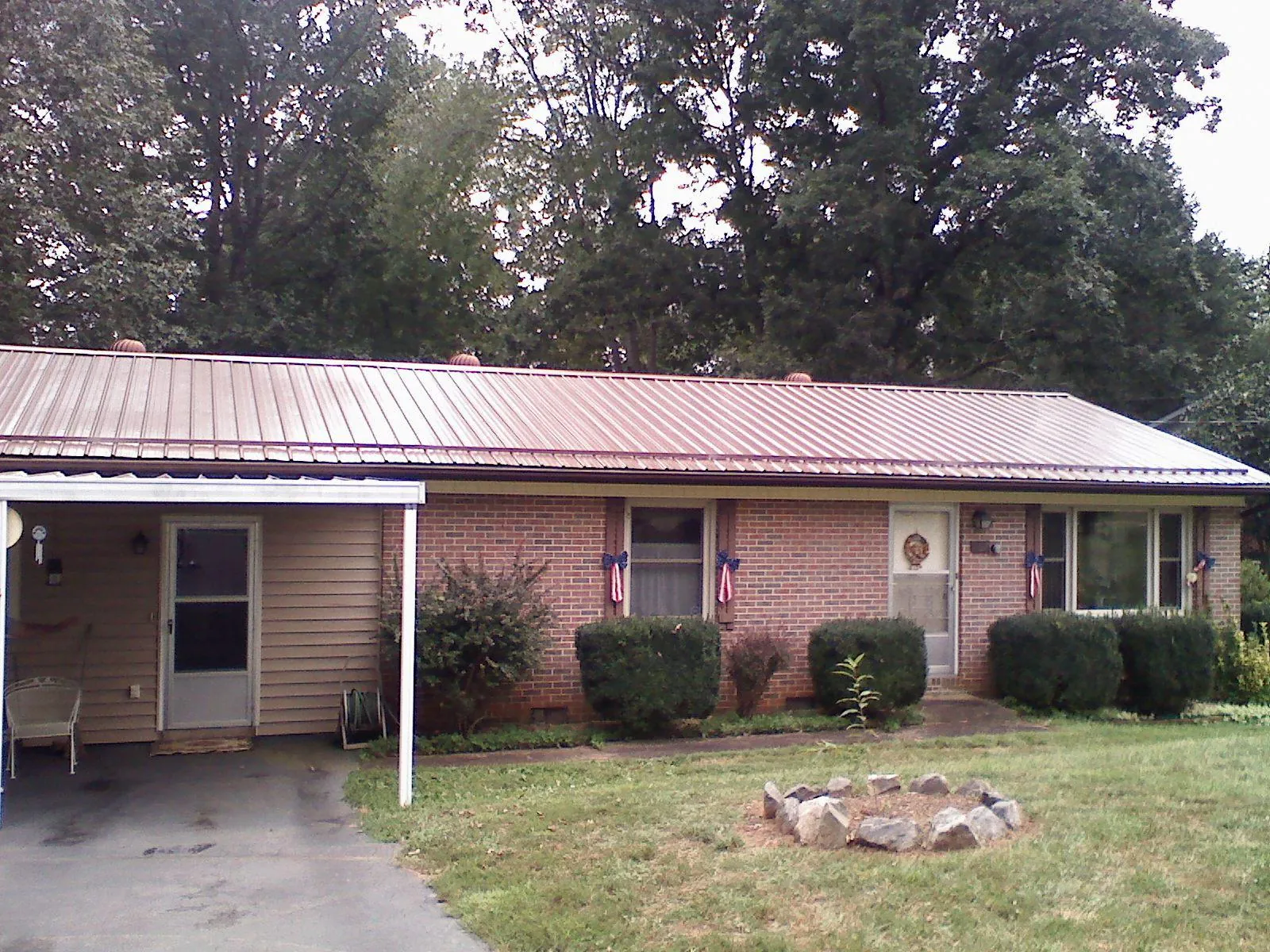 Bronze metal roof and carport on a brick ranch home — Roof Repair work by our crew in Shippingport
