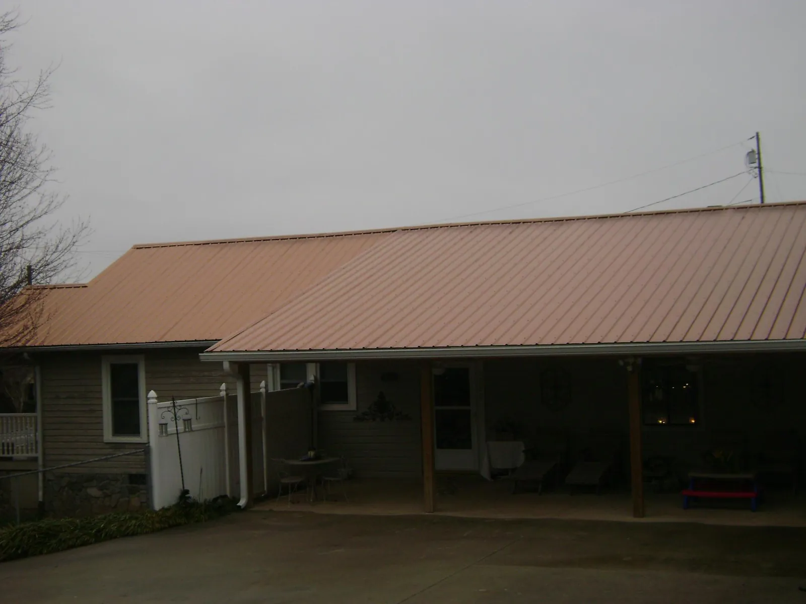 Copper toned metal roof over a wide covered patio in Shippingport